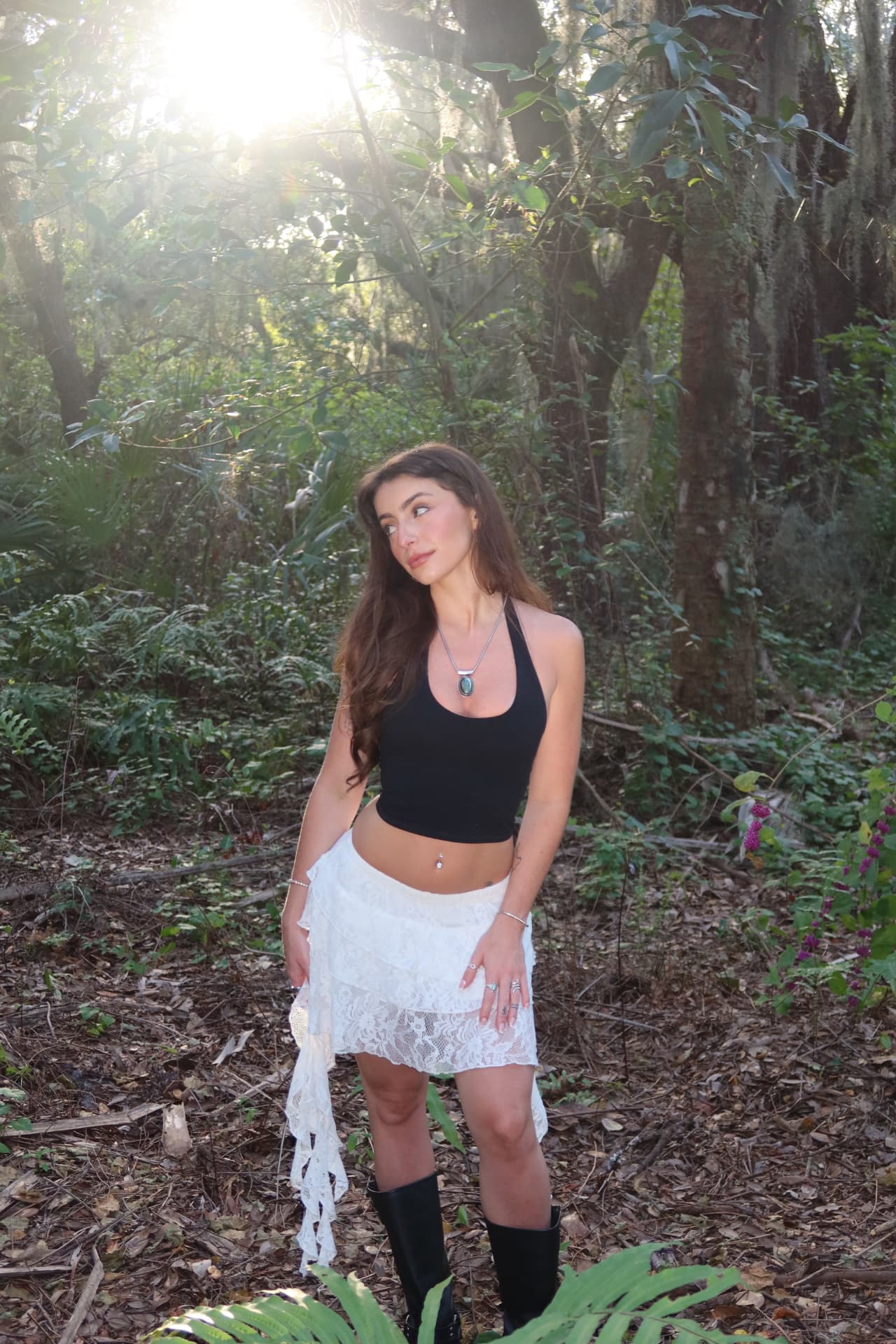 Julia Melo standing in golden forest light